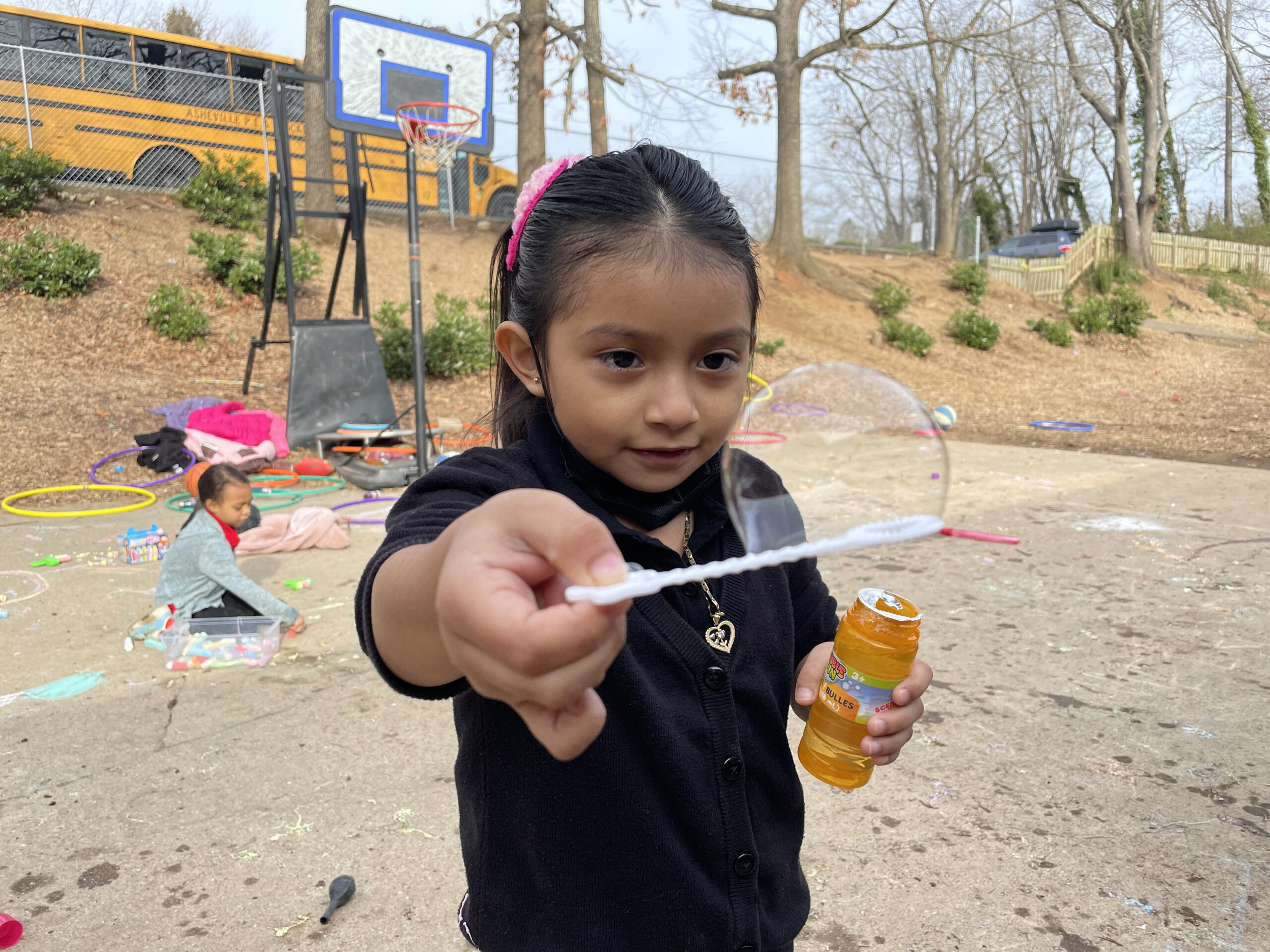 Hispanic child on playground with toy