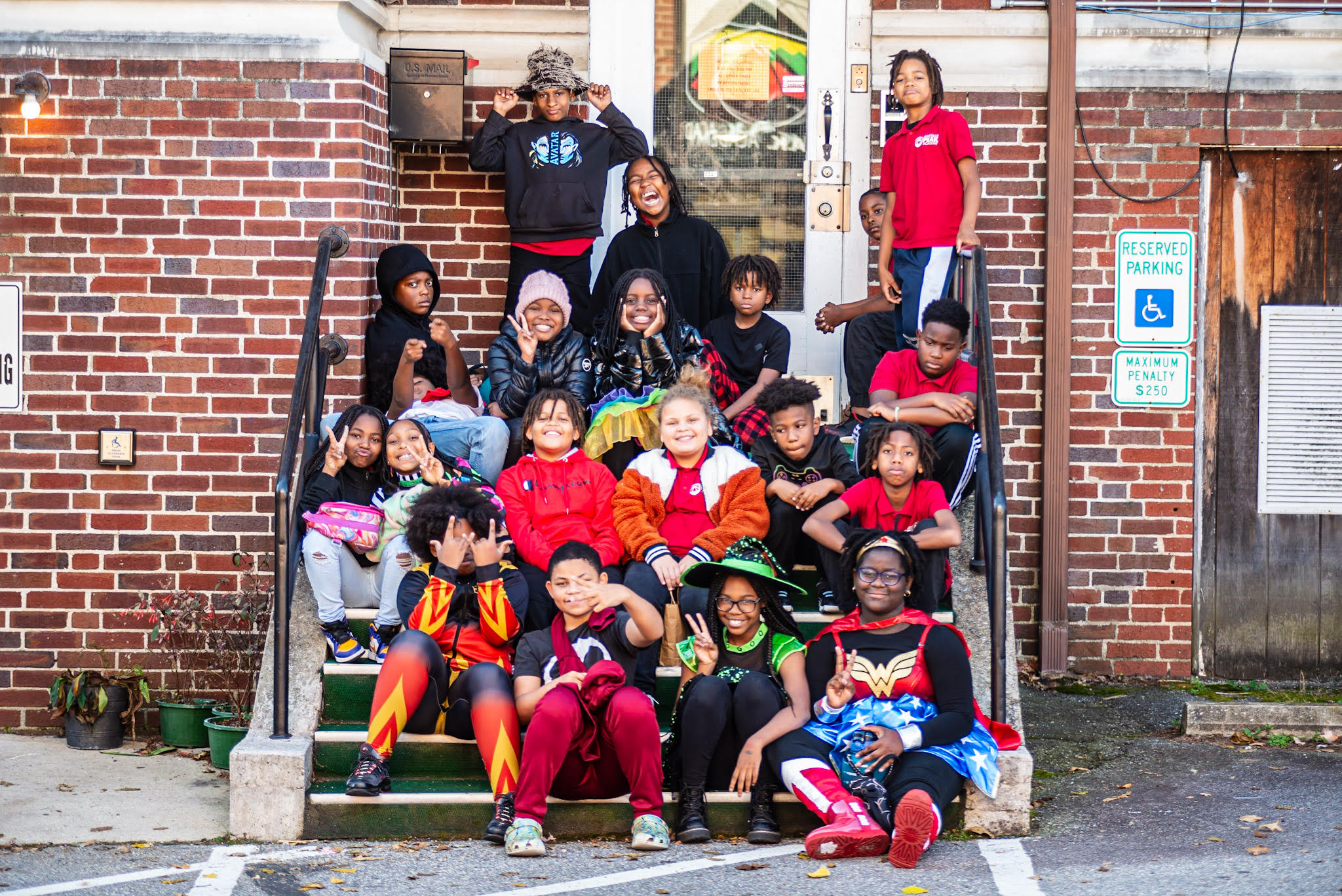 A group of school kids sitting on the doorstep of the church at PEAK